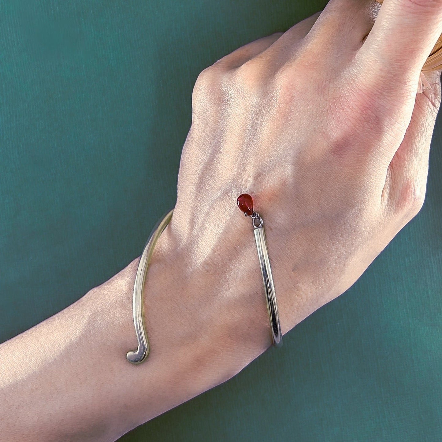 handmade on of a kind silver swirl bracelet with red glass drop