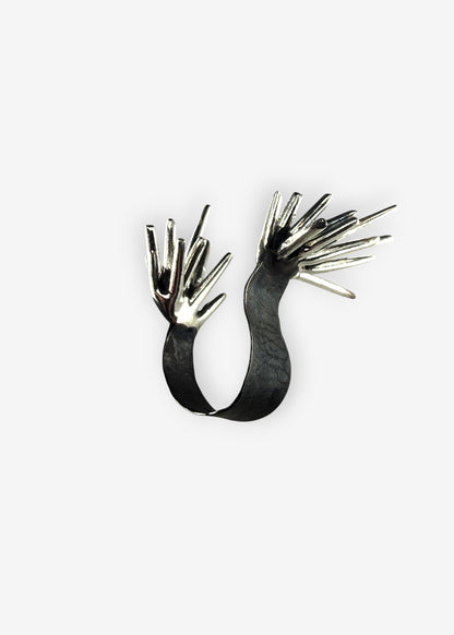 Sterling silver Beam Apart ring with opposing spike structures open design front view on white background