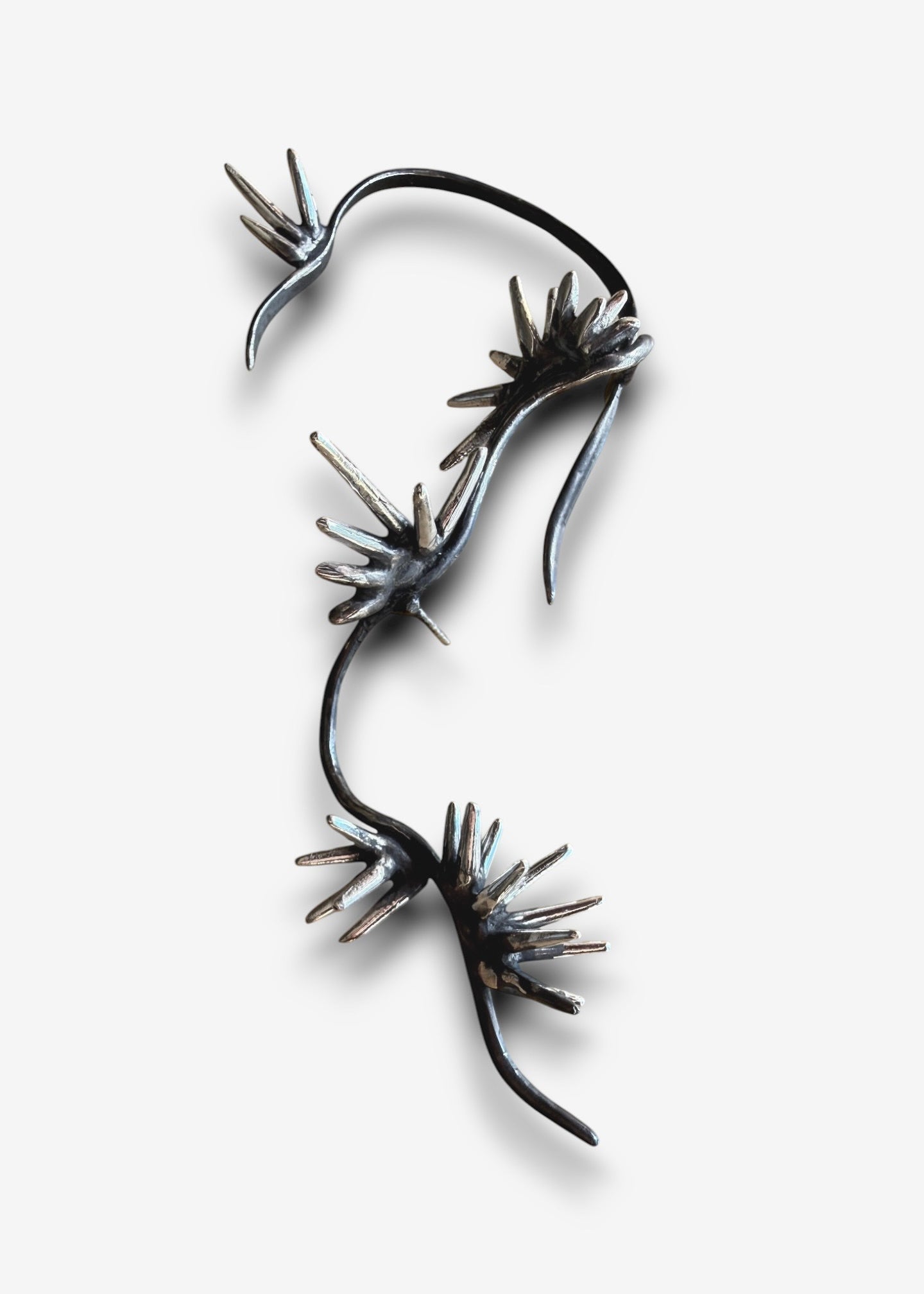 Sterling silver sculptural ear cuff with branching spike design Beam Collection left ear cuff isolated on white background