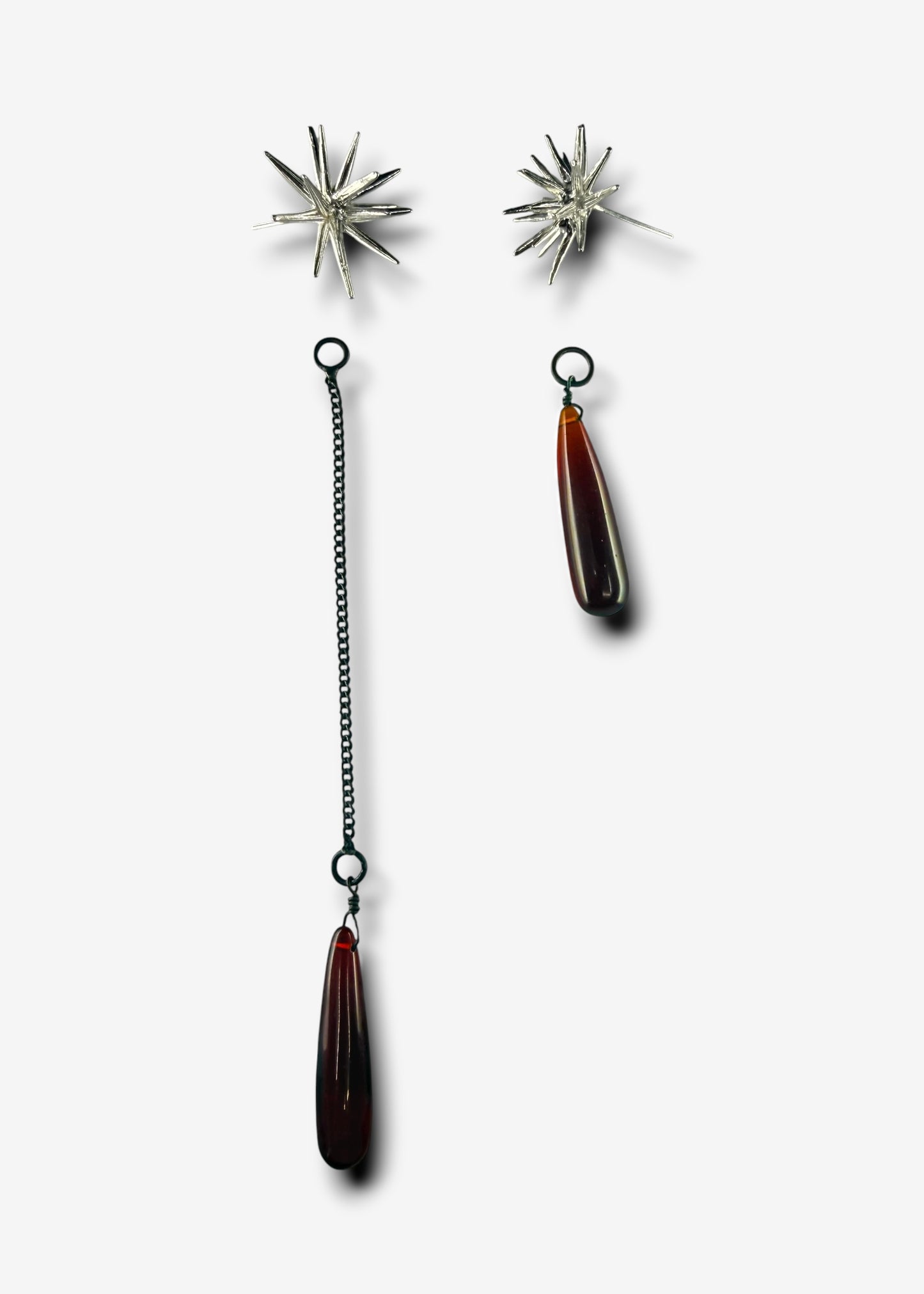 Sterling silver Beam stud earrings with detachable ruby quartz drop pendants and chain, laid out separately.
