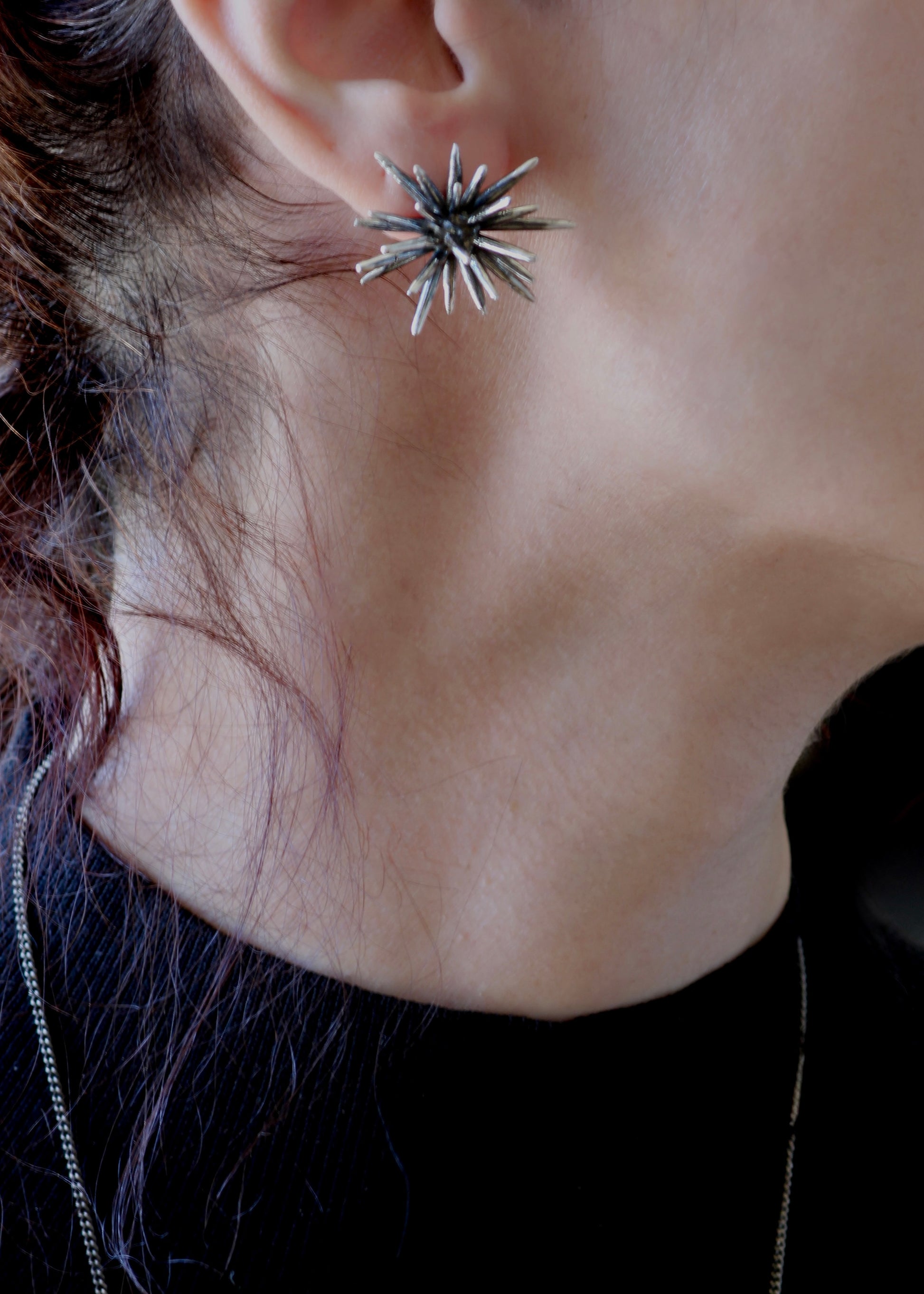 Sterling silver Beam stud earring worn on ear, sculptural spiked design, bold yet wearable everyday jewelry