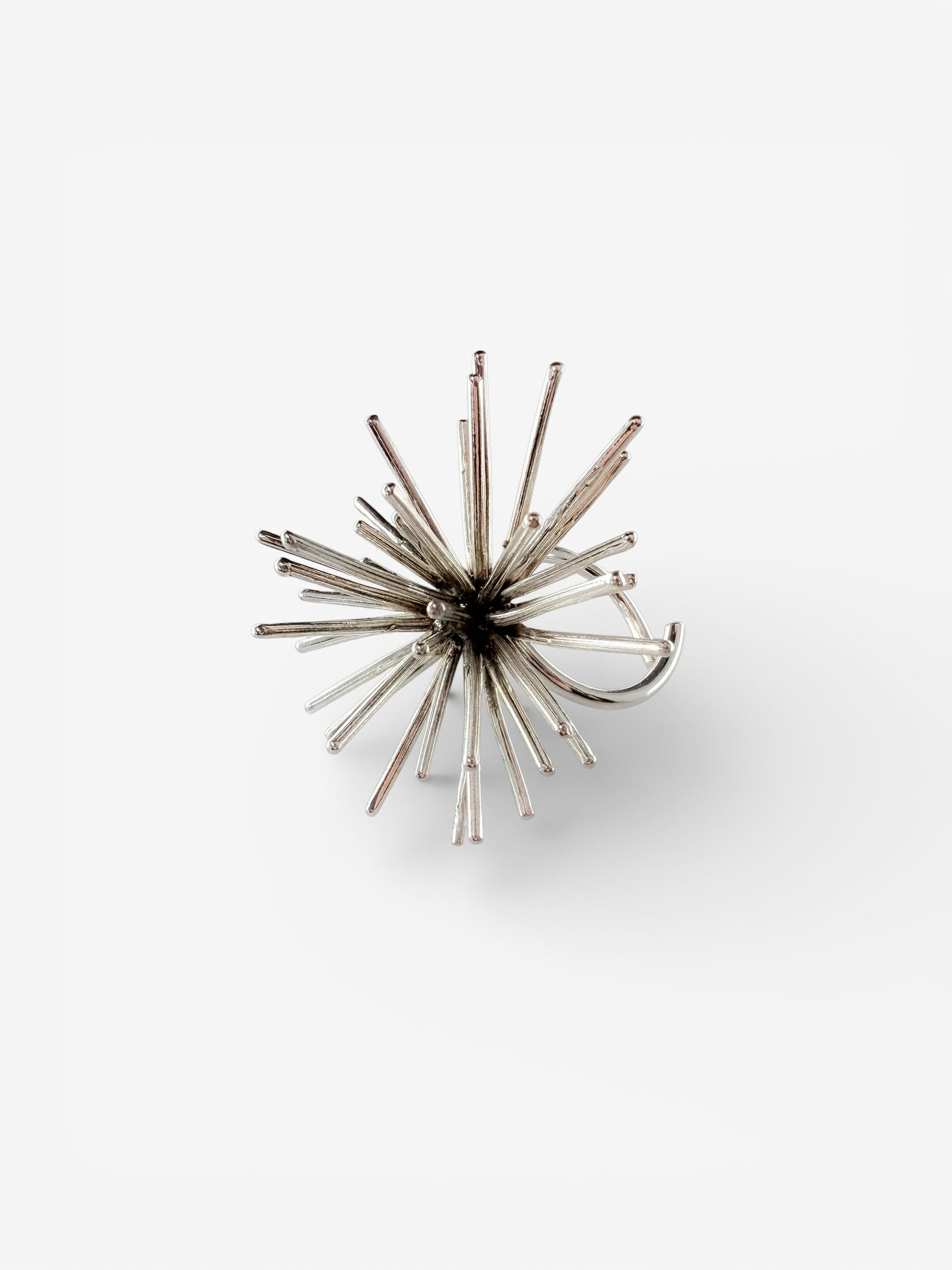 Handmade sterling silver Beam ring by Ninimosi, sculptural spike design with adjustable band on white background