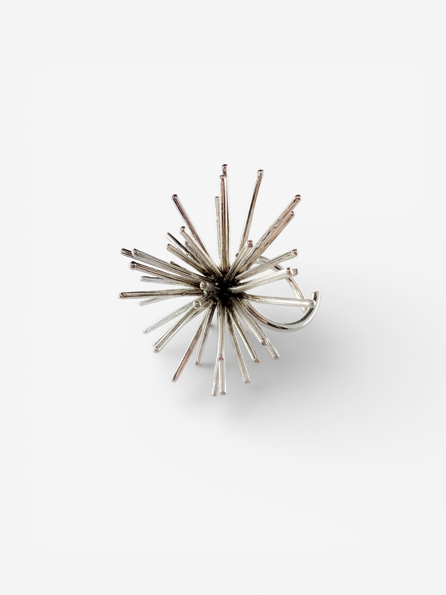 Handmade sterling silver Beam ring by Ninimosi, sculptural spike design with adjustable band on white background