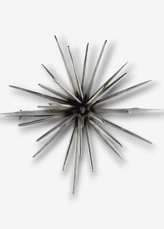 Handmade sterling silver sculptural brooch by Ninimosi, asymmetrical spike design on white background