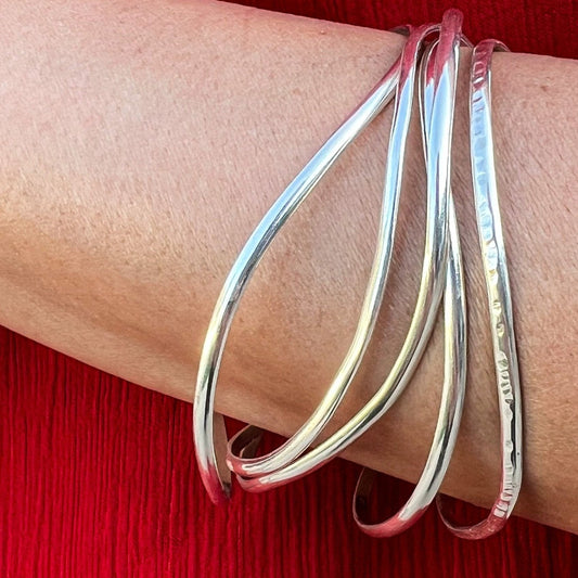 Stack of silver bracelets
