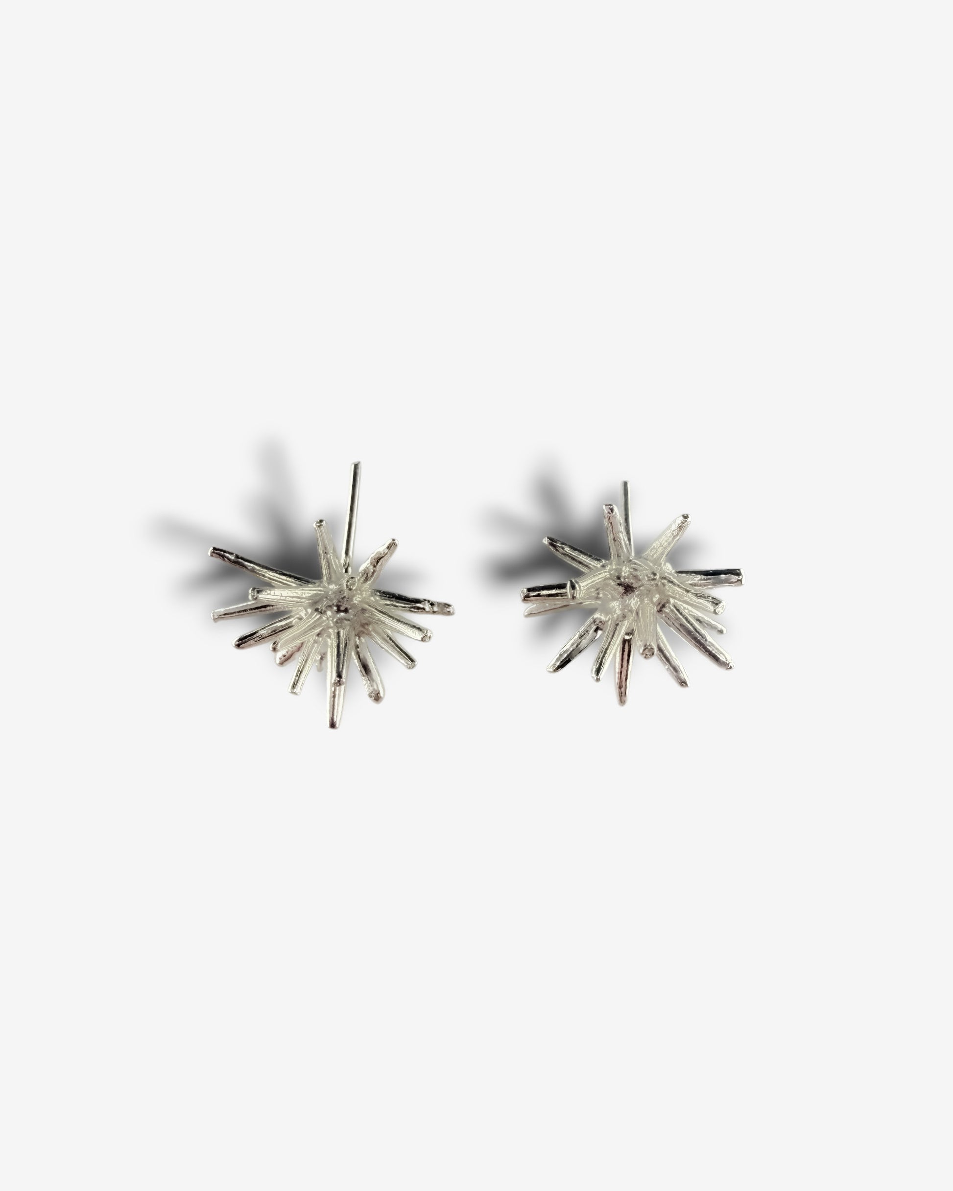 Handmade sterling silver Beam stud earrings by Ninimosi, sculptural spike design on white background