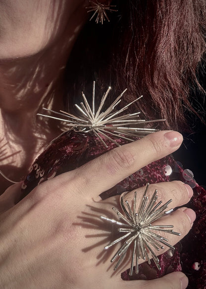 Handmade sterling silver Beam ring and brooch by Ninimosi worn together, sculptural spike jewelry catching sunlight on body