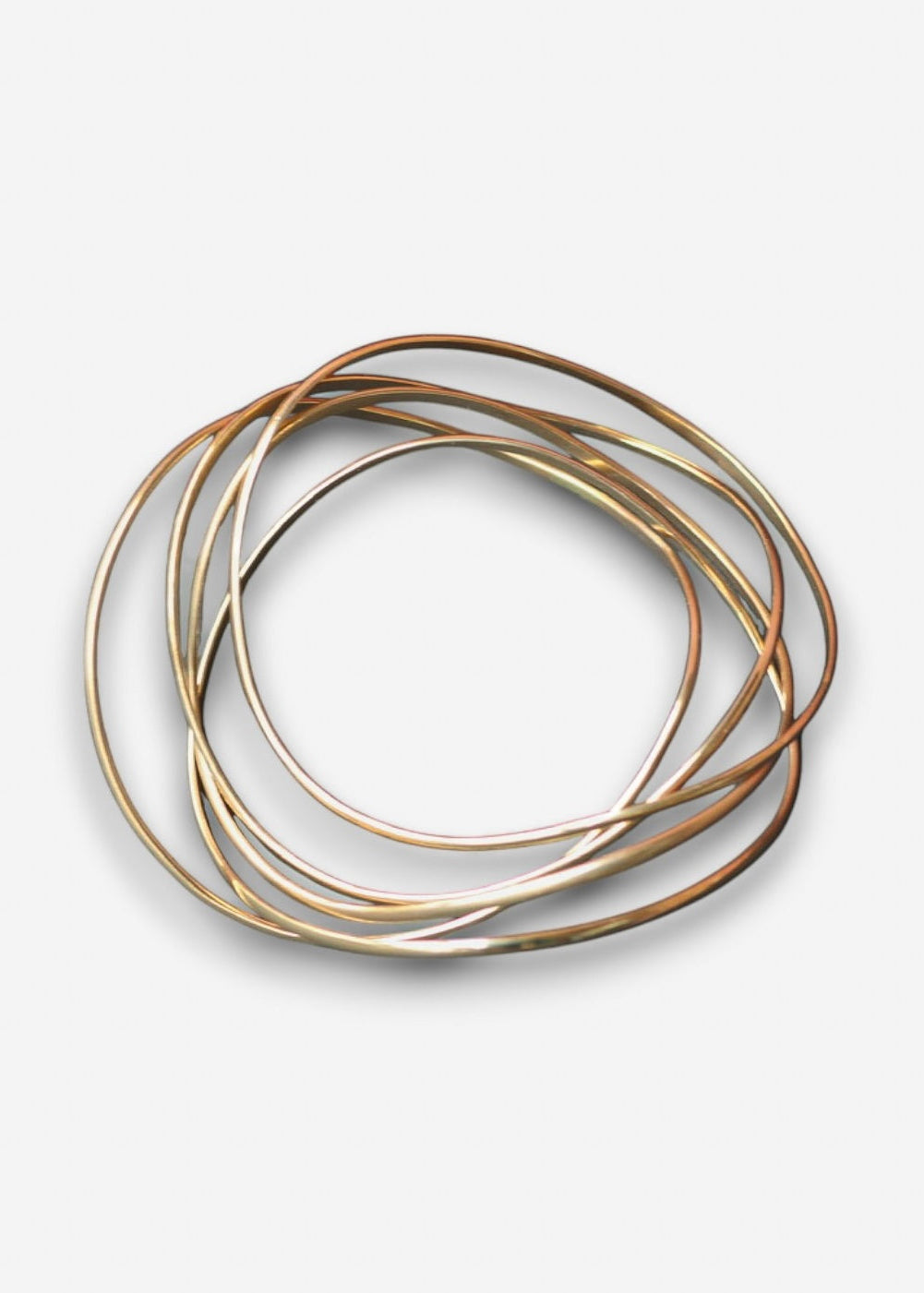 Handcrafted wave bangle stack in gold on a clean background