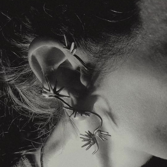 Sterling silver spike ear cuff wrapping along ear sculptural design Beam Collection close up on ear