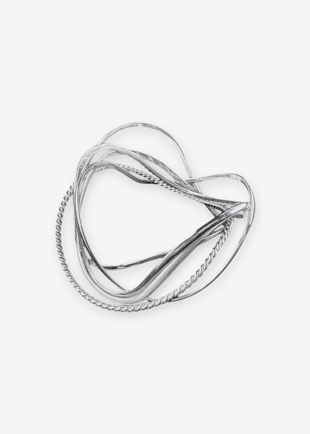 handcrafted silver wave bangle stack on neutral background, sculptural stackable jewelry in precious metal